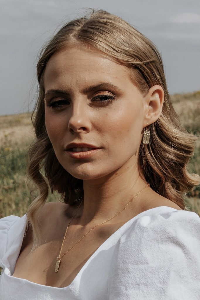 Model wears Wisteria London Meredith Wildflower Earrings