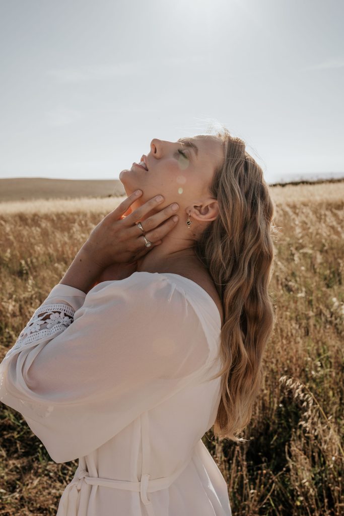 Model Wears Orion Planet and Star Huggie Hoop Earrings
