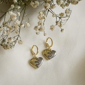 Mixed metal heart huggie hoop earrings with gold and silver finish, dainty love-inspired jewellery perfect as a gift or everyday wear
